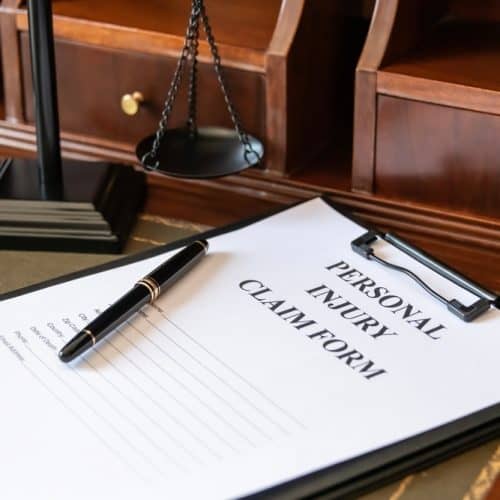 Legal,Personal,Injury,Claim,Form,With,Scales,Of,Justice