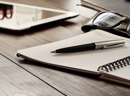 Open,Notebook,,Tablet,Computer,,Glasses,And,Folders,On,The,Office