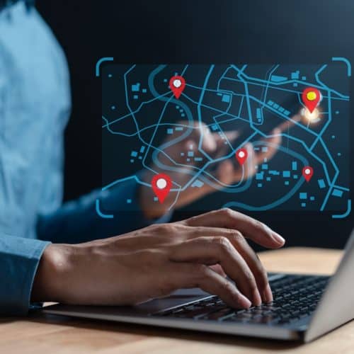Businessman,Using,Smartphone,Synchronize,Computer,Searching,World,Map,With,Location