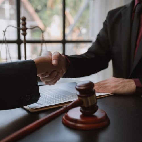 Businessmen,Shaking,Hands,To,Sign,Agreement,With,Lawyer,Or,Legal