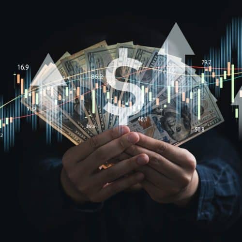 Businessman,Holding,Dollar,Banknote,With,Stock,Market,Graph,And,Up