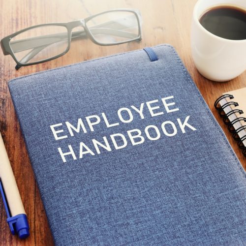 Concept,Image,Of,Employee,Handbook,Over,Wooden,Office,Table.,Top