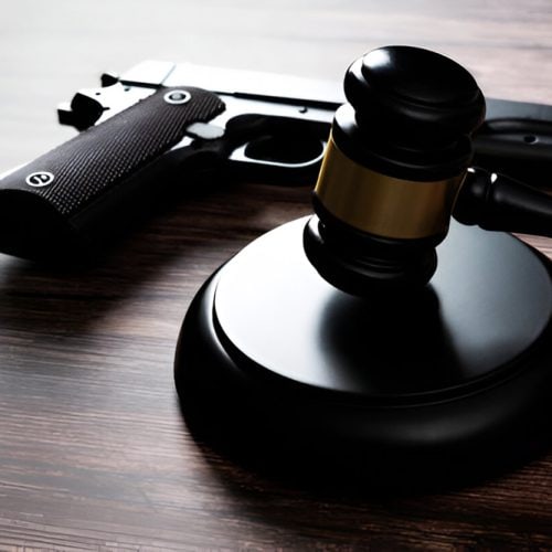Gun,And,Gavel,On,The,Table.