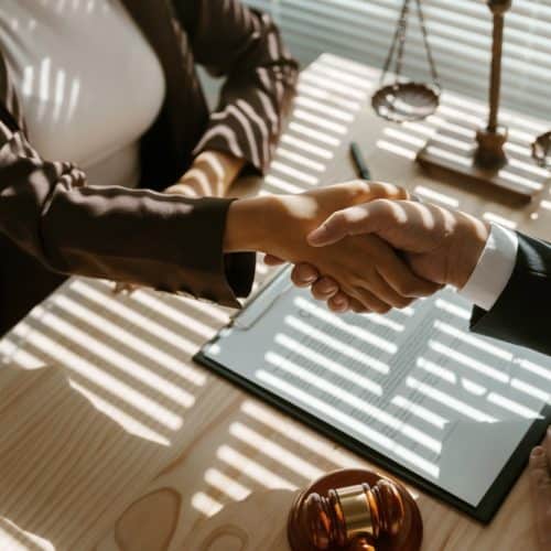 Lawyers,Shaking,Hands,After,Signing,A,Contract,In,A,Law