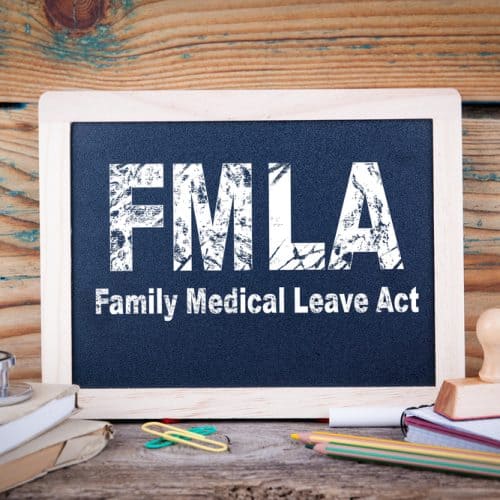 Fmla,,Family,Medical,Leave,Act.,Chalkboard,On,A,Wooden,Background