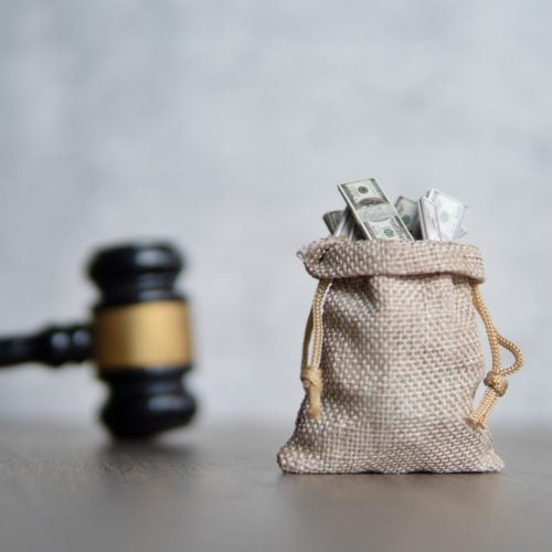 Closeup,Image,Bag,Of,Money,And,Judge,Gavel.,Lawsuit,,Auction,