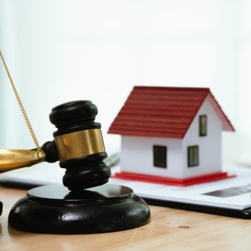 A,Gavel,,House,Model,,And,Keys,Rest,On,A,Table