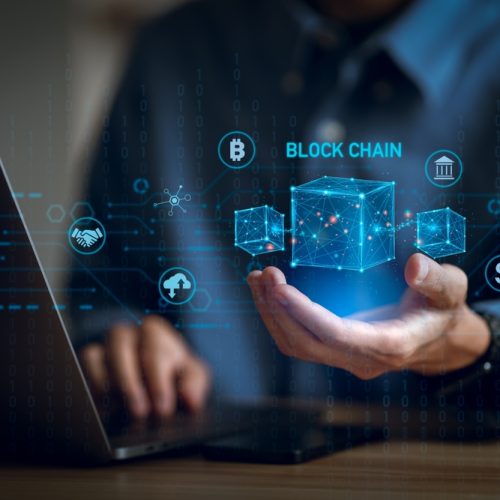 Businessman,Using,A,Computer,And,Blockchain,Icon,In,Hand,To