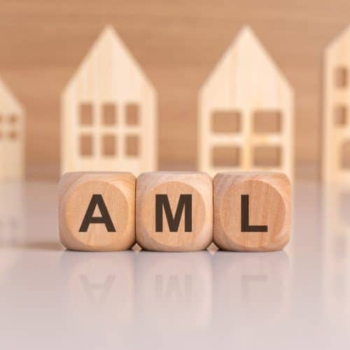 Wooden,Cubes,Spelling,Aml,In,Front,Of,Model,Houses,,Symbolizing