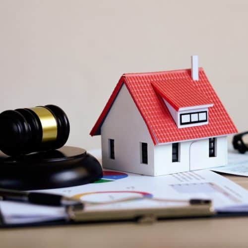 Mini,House,On,Judges,Gavel,,Legal,Book,Beside,It,real estate