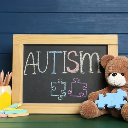 Small,Blackboard,With,Word,Autism,,Toy,Bear,And,Stationery,On