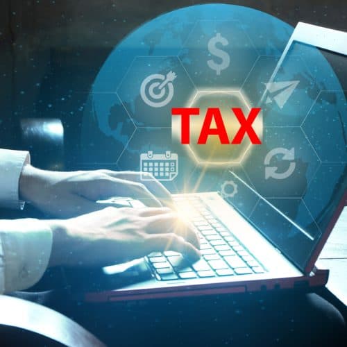 Businessman,Using,Software,Programs,From,Laptop,Flying,Icons,With,Tax