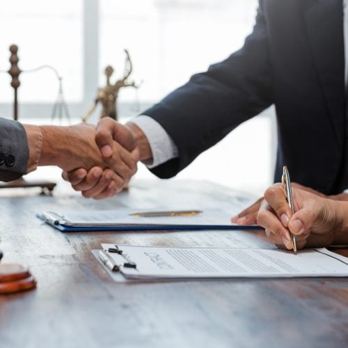 Legal,Professionals,Completing,A,Deal,,Clients,Signing,Documents,With,A