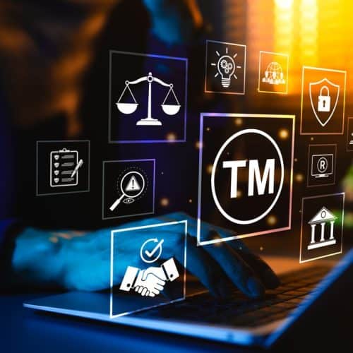 Trademark,Protection,Concept.,Person,Typing,On,Laptop,Surrounded,By,Icons