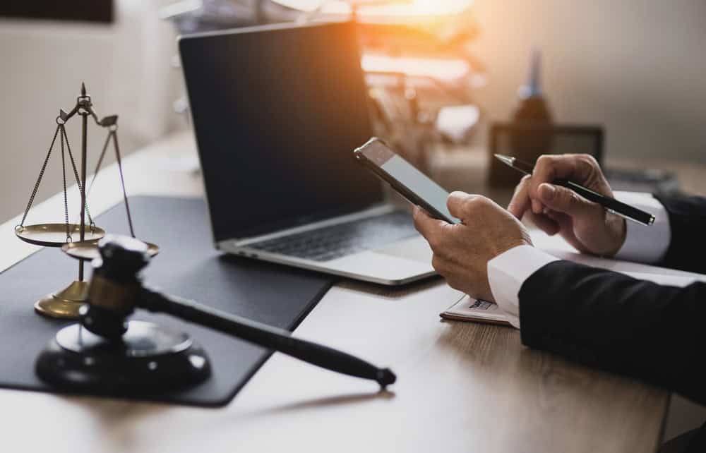 Lawyer,Hands,Working,With,Smartphone,And,Laptop,On,Table,Office,
