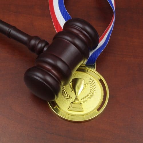 Wooden,Judge,Gavel,And,Gold,Medal,With,Trophy,Cup,Close