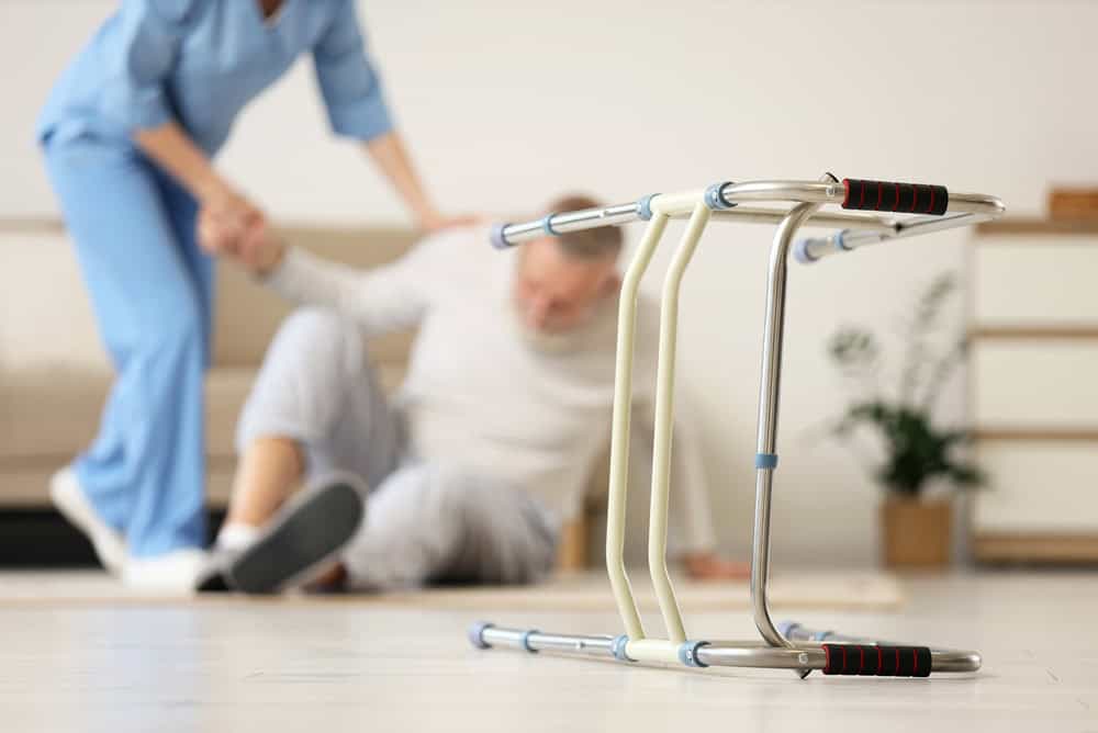 Walker,Against,Nurse,Helping,Senior,Man,To,Stand,Up,After