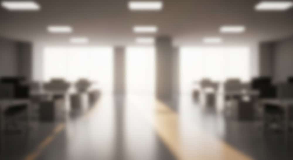 Blurred,Office,Space,Empty,Desks,With,Bright,Window,,And,Modern