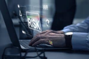 Businessman,Using,Laptop,,Closeup.,Scheme,With,Word,Risk,And,Different