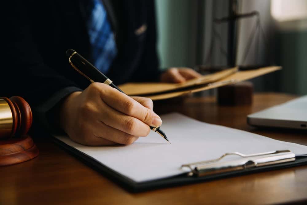 Business,And,Lawyers,Discussing,Contract,Papers,With,Brass,Scale,On
