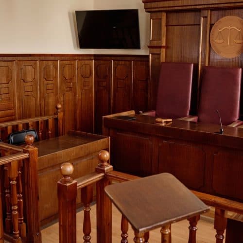 Corner,Of,Courtroom,With,Wooden,Desks,And,Railings,And,Leather