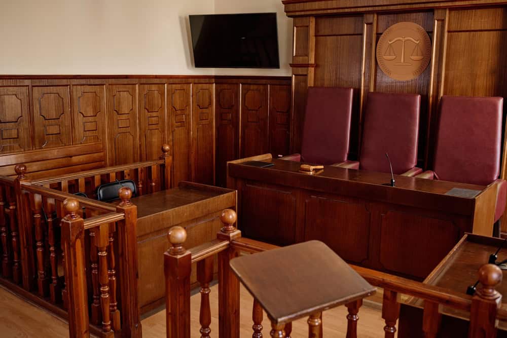Corner,Of,Courtroom,With,Wooden,Desks,And,Railings,And,Leather